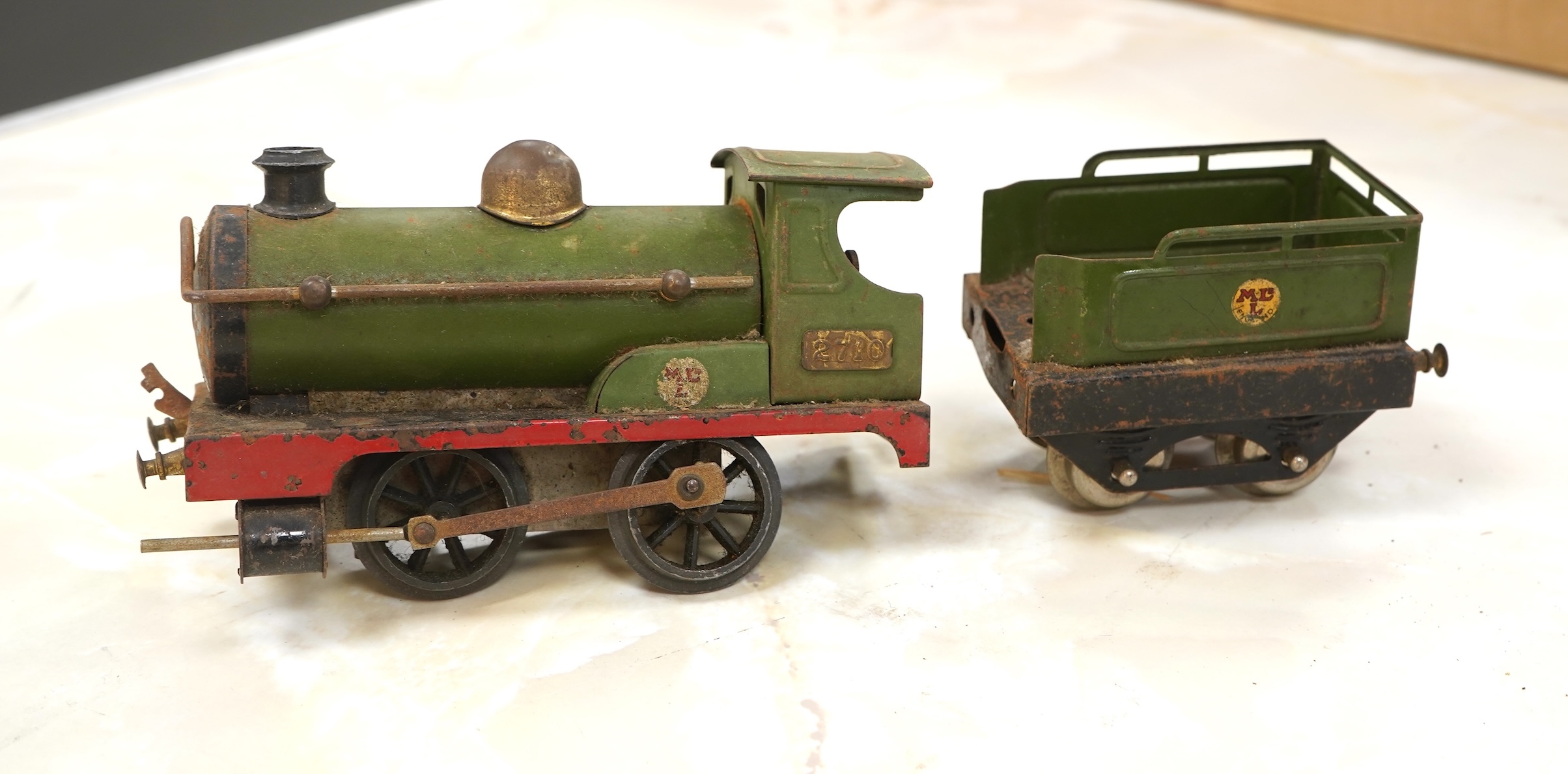 A Bing for Bassett Lowke 0 gauge tinplate clockwork LNER Ivatt 4-4-0 tender locomotive, 4390, together with an early Hornby clockwork 0-4-0, 2710, in GNR green livery with Meccano Ltd roundels to locomotive splasher and